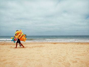 Men on beach against sky