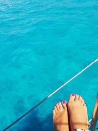 Low section of woman legs in swimming pool