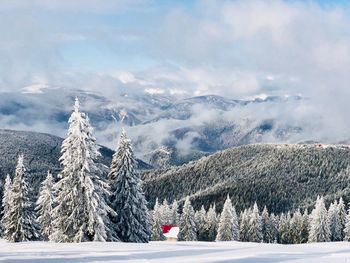 Scenic view of snow covered mountains against sky