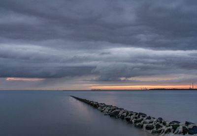 Scenic view of sea against storm clouds