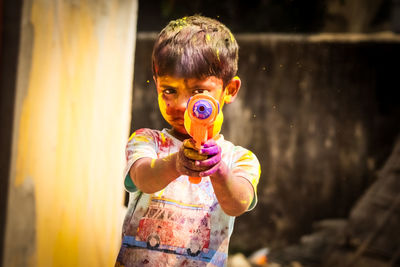 Boy blowing bubbles while standing outdoors