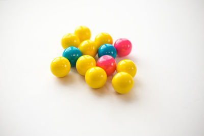 Close-up of colorful candies against white background