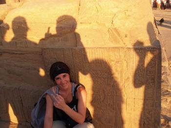Portrait of smiling young woman sitting outdoors