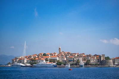 Boats in harbor with buildings in background