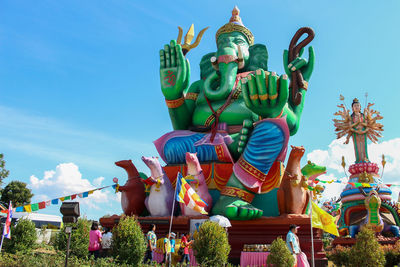 Low angle view of religious statues against sky