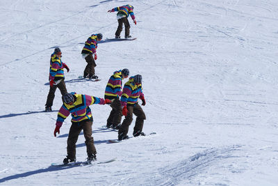 People skiing on snow covered mountain