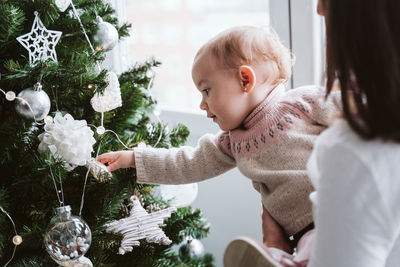 Mother with baby girl at home during christmas