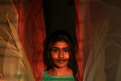 Portrait of beautiful woman standing amidst netting