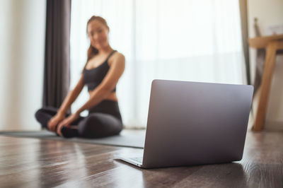 Young woman using laptop at home