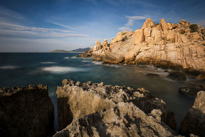 Scenic view of sea and mountains against sky