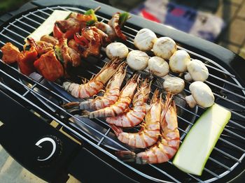 High angle view of meat on barbecue