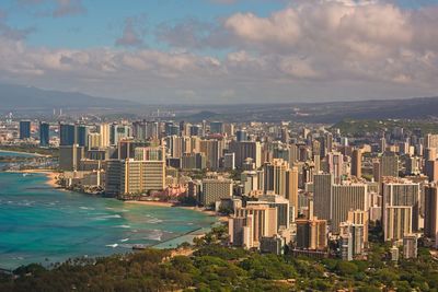 Aerial view of city by sea