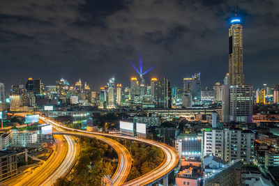 Illuminated buildings in city against sky at night