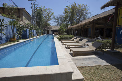 View of swimming pool by building against sky