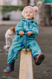 Portrait of cute boy sitting on chair