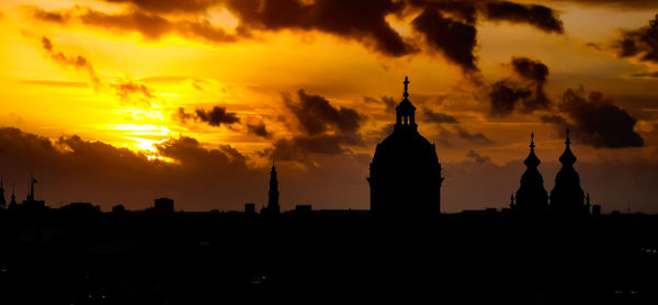 Silhouette temple against sky during sunset