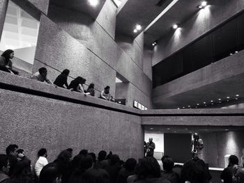 Group of people standing in illuminated corridor