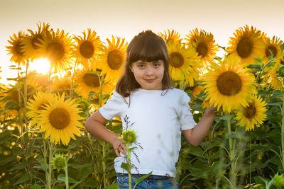 Low angle view of woman standing on sunflower