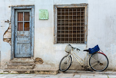 Bicycle leaning against wall of building