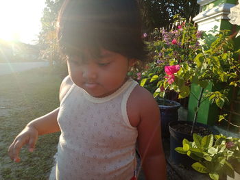 Cute girl looking at flowering plants