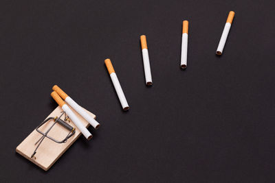 High angle view of pencils on table against black background