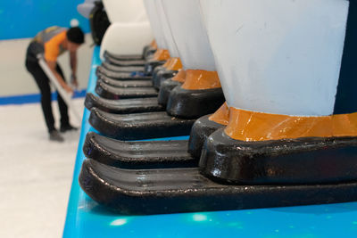 Close-up of worker working on blue metal