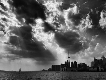 City skyline against cloudy sky