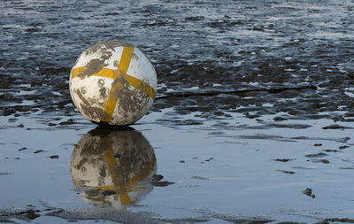 High angle view of yellow ball on beach