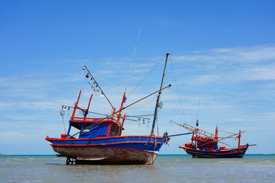 The old fishing boat the wooden made on the sand beach natural thailand seascape background