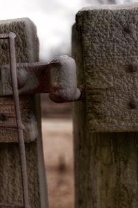 Close-up of wooden post against sky