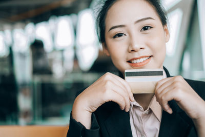 Portrait of a smiling young woman using smart phone