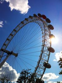 Low angle view of ferris wheel against blue sky