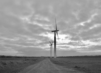 Windmill on field against sky