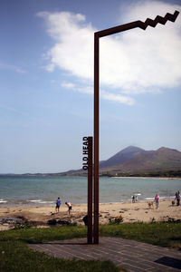 People on beach against sky