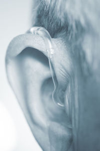 Close-up of man making face against white background