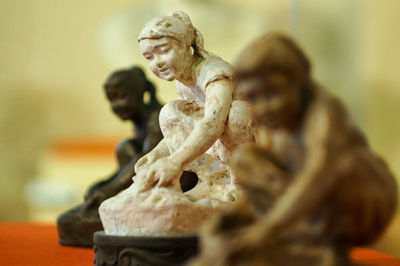 Close-up of small sculptures in museum