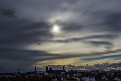 City against cloudy sky at sunset