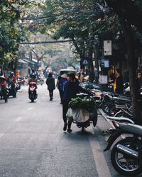 People walking on road in city