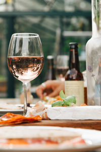 Close-up of wineglass by food on dining table at yard