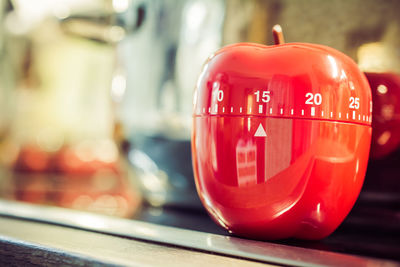 Close-up of red container with numbers on table