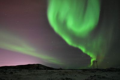 Scenic view of landscape against sky at night