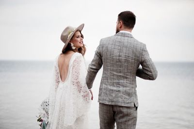 Bride and bridegroom standing at beach during wedding ceremony