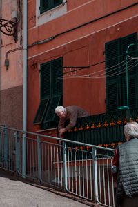 Full length of man walking on street against building in city