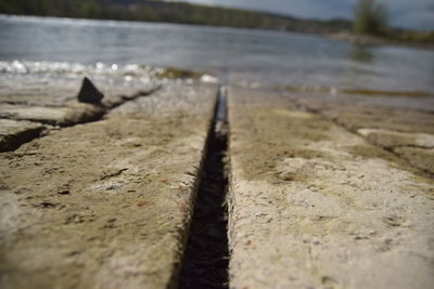 Close-up of metal railing on beach