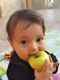 Portrait of cute boy eating fruit