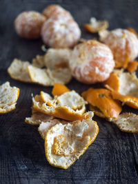 Close-up of peeled oranges on wooden table