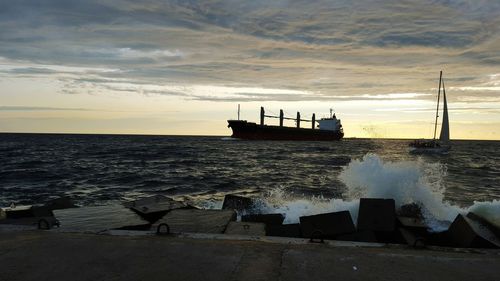 Side view of ship in calm sea against the sky