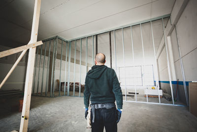 Rear view of man standing in building