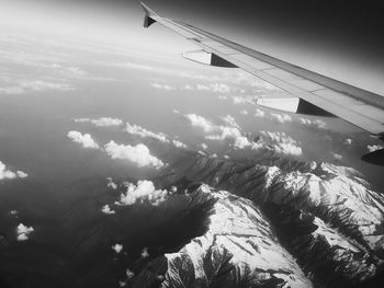 Low angle view of airplane wing against sky