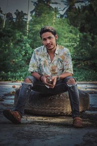 Portrait of young man sitting outdoors